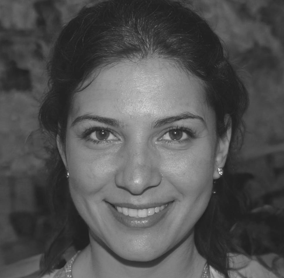 Female financial professional reviewing budget performance metrics on laptop in modern office environment