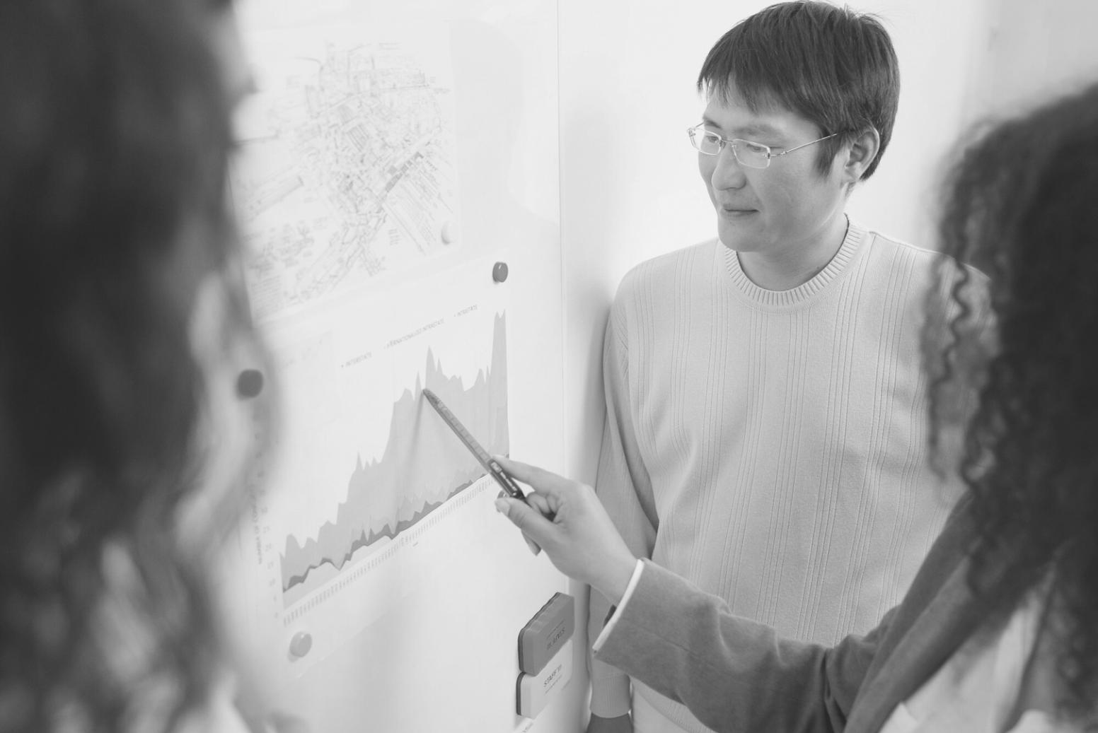 Business professional analyzing financial data patterns on tablet with charts and graphs